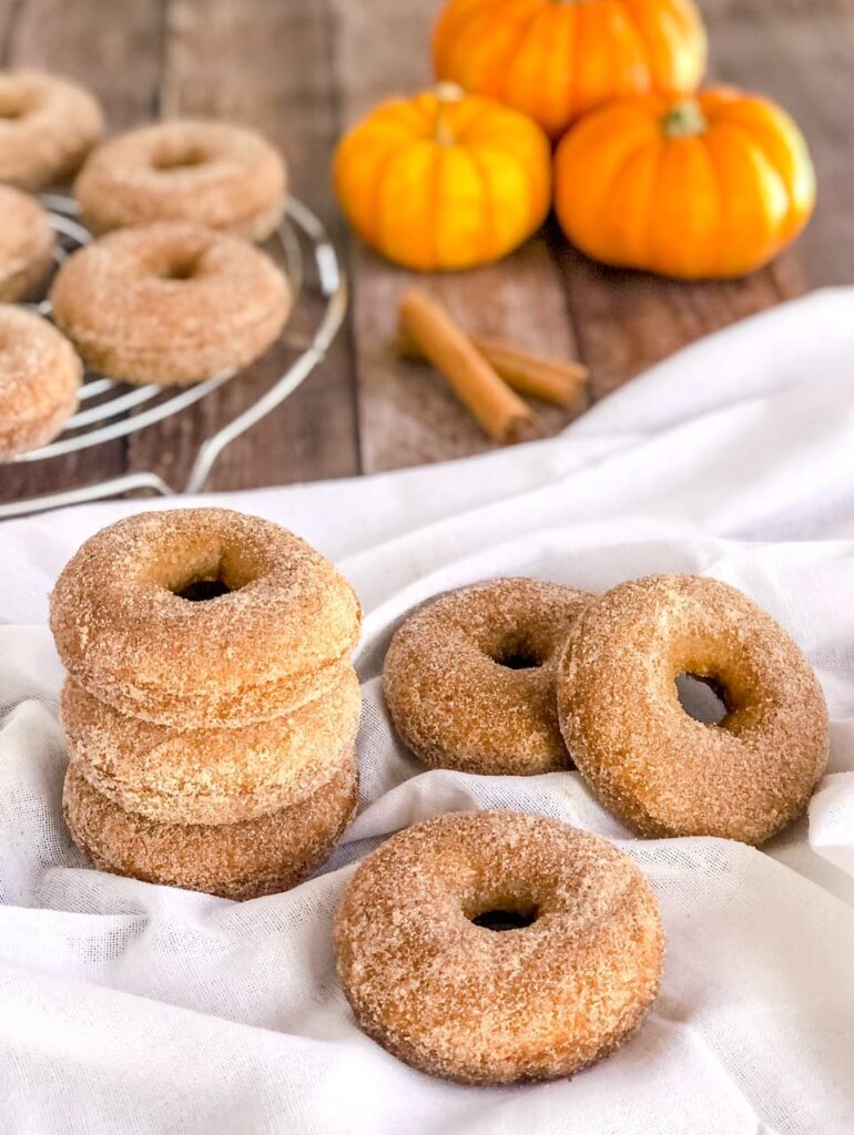 stack of pumpkin spice donuts with pumpkins