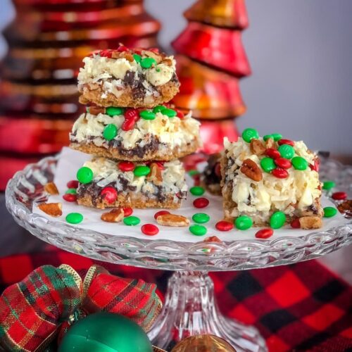 holiday magic bars on a glass cake plate