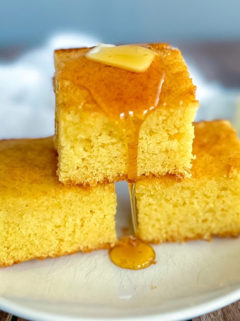slices of cornbread with butter and dripping honey