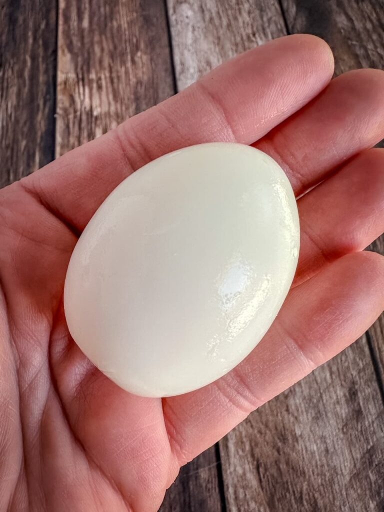 peeled egg in a hand