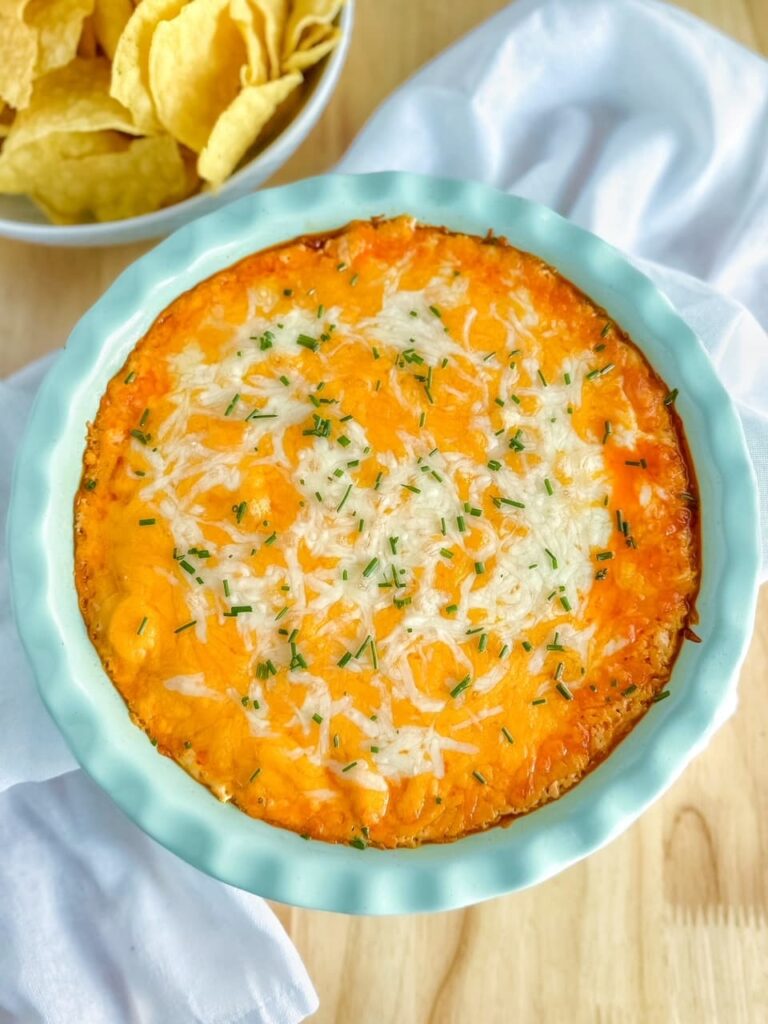 buffalo chicken dip with a bowl of tortilla chips