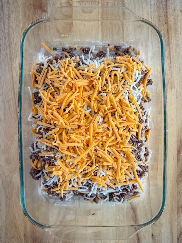 shredded cheese over beef