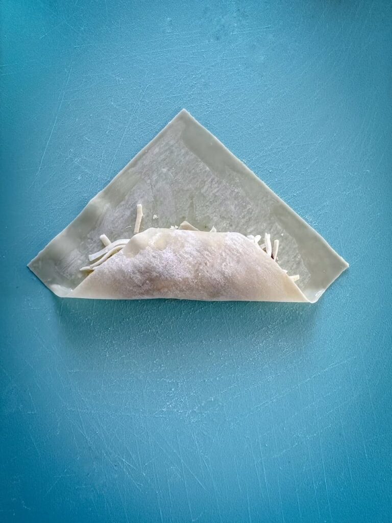 egg roll wrapper filled with one fold