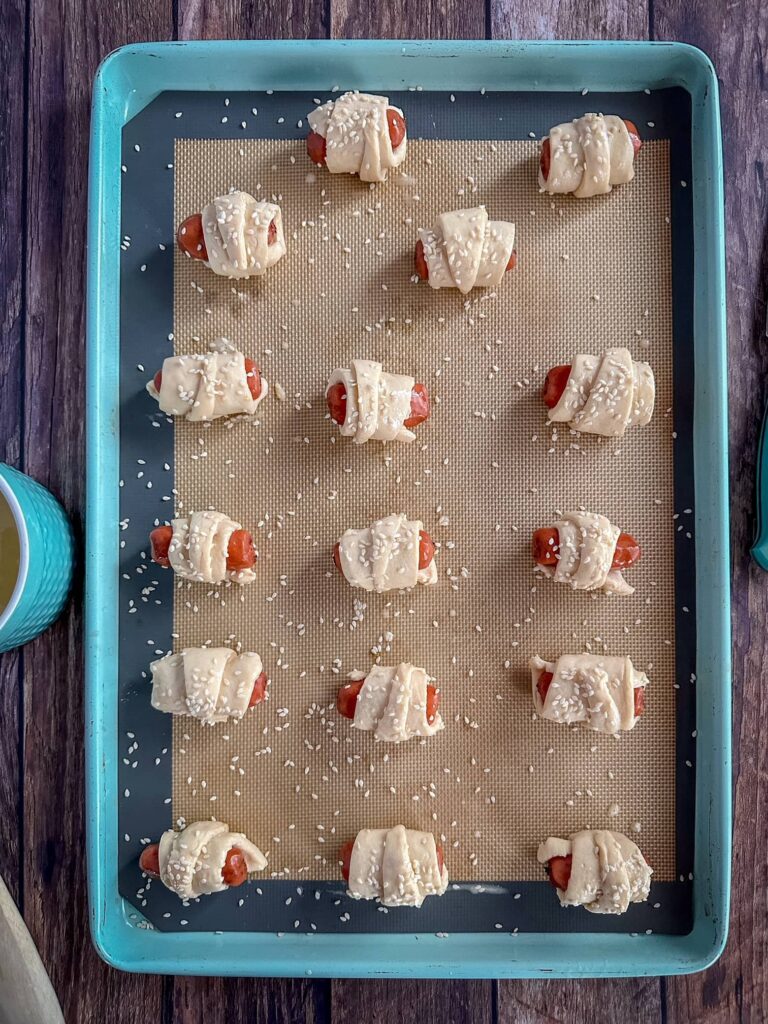 pigs in a blanket with egg wash and sesame seeds