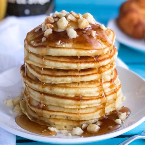 stack of pancakes with nuts and syrup