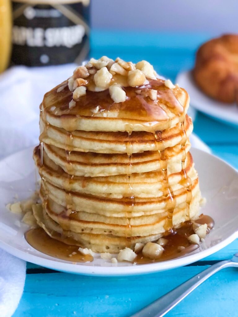 stack of pancakes with nuts and syrup
