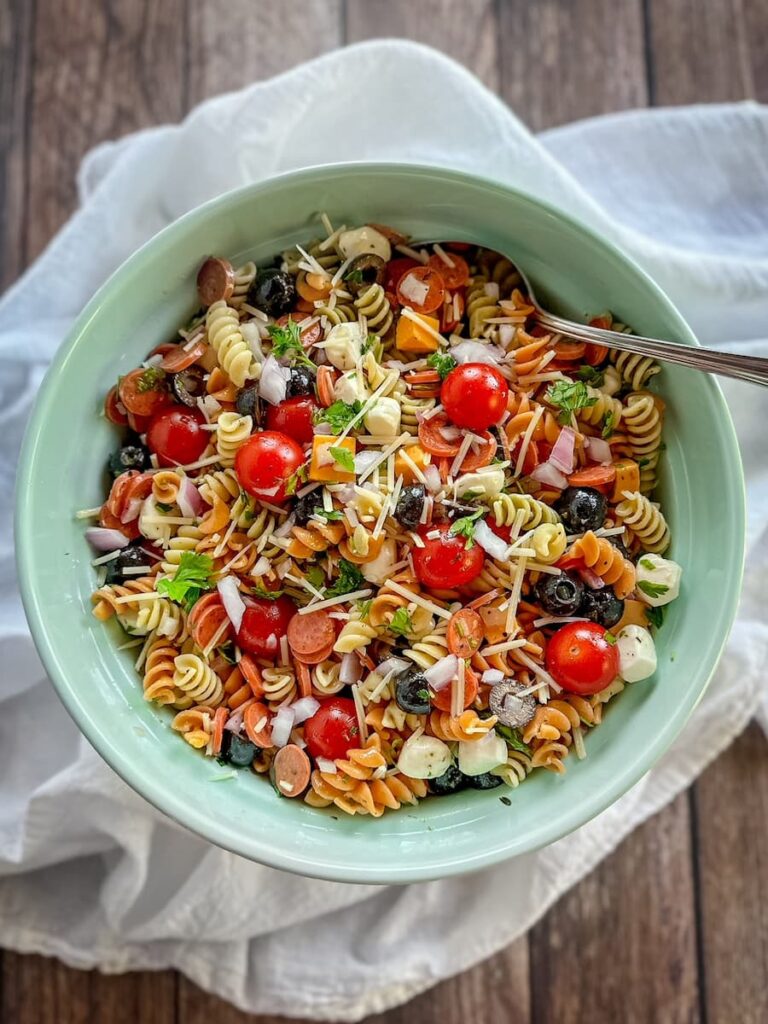 italian pasta salad in a bowl with a spoon