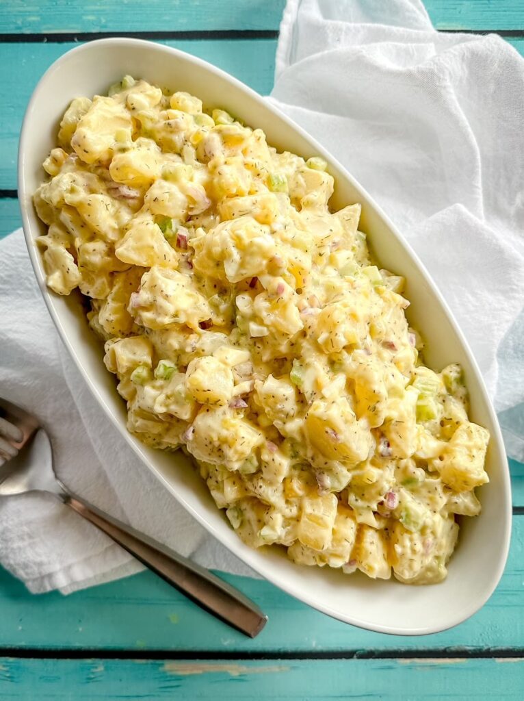 the best potato salad in a white bowl