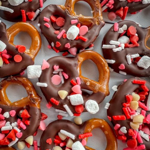 pretzels dipped in chocolate and decorated with sprinkles