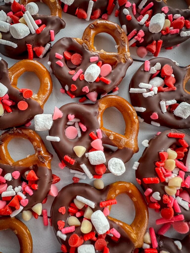 pretzels dipped in chocolate and decorated with sprinkles