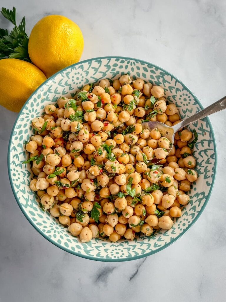 lemon herb chick pea salad in a bowl with a spoon