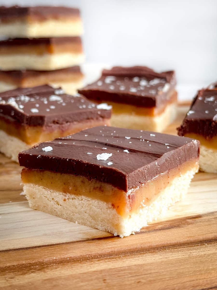 millionaire shortbread bars on a wooden board