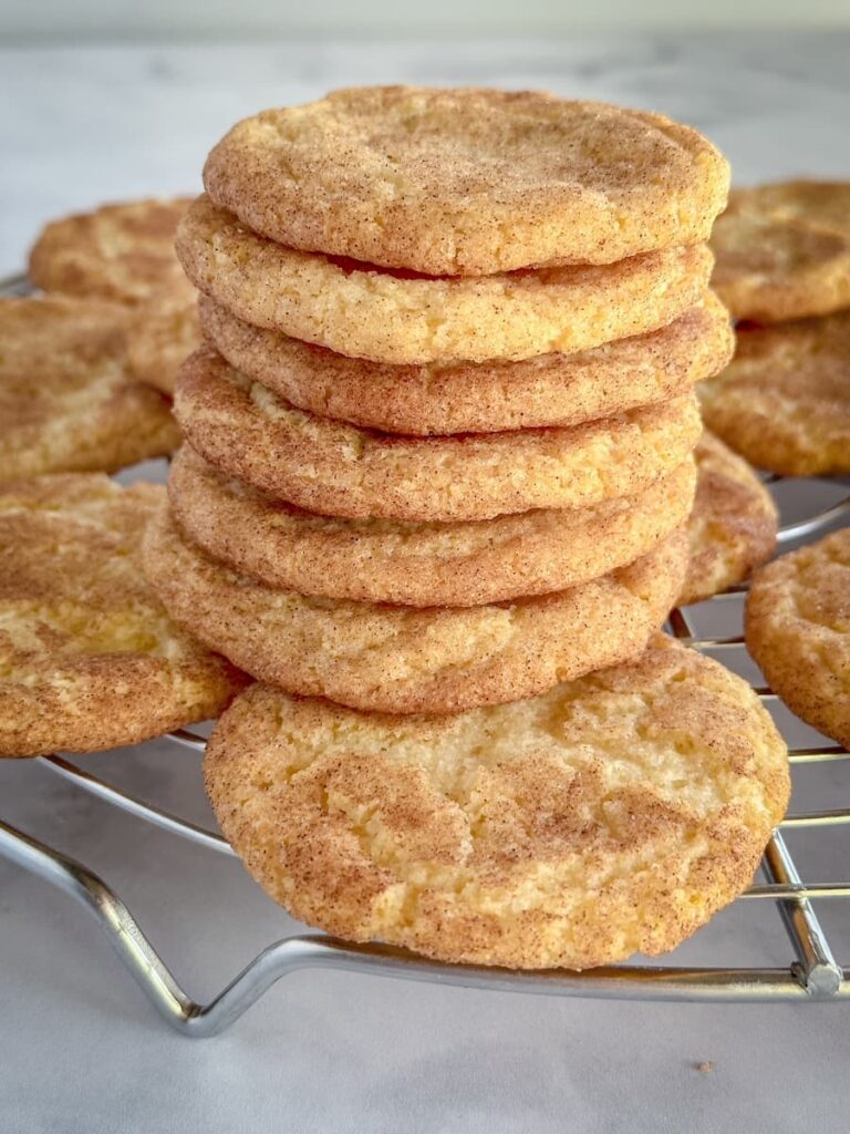 snickerdoodles stacked on a cooling rack