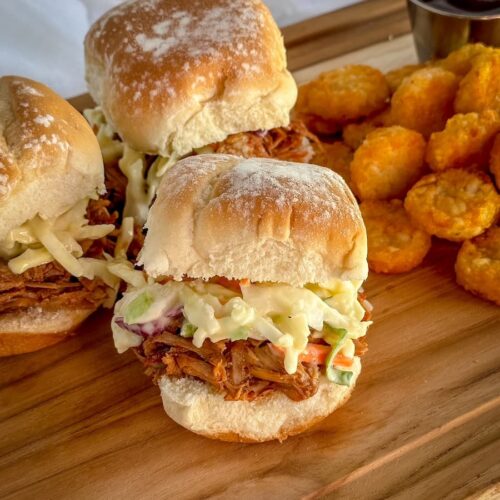 slow cooker bbq pork on sliders with coleslaw and tater tots