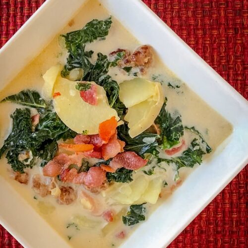 Bowl of creamy Zuppa Toscana soup with sausage, potatoes, and kale