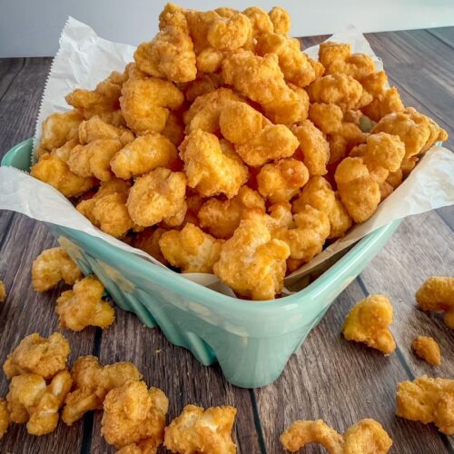 A bowl filled with buttery homemade caramel puff corn.