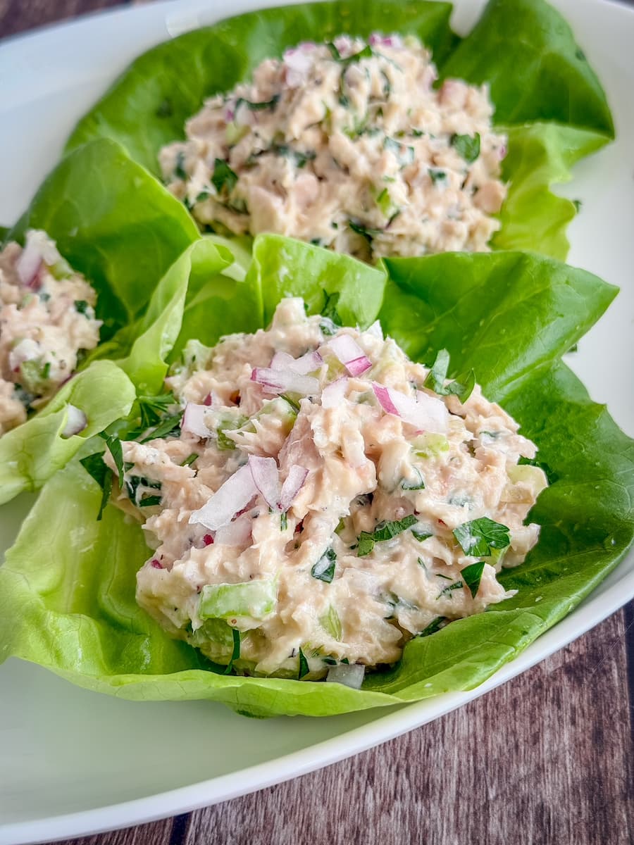 Creamy homemade classic tuna salad made with white albacore tuna, celery, red onion, parsley, mayonnaise, Dijon mustard, and lemon juice served in lettuce cups